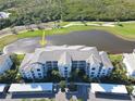 Panoramic aerial view of the condo complex, showcasing water feature and surrounding greenery at 14081 Heritage Landing Blvd # 232, Punta Gorda, FL 33955