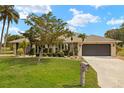 Well-maintained home with lush lawn, mature landscaping, and inviting curb appeal at 1452 Wassail Ln, Punta Gorda, FL 33983