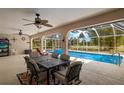 Covered patio with dining set and a view of the screened-in pool at 1452 Wassail Ln, Punta Gorda, FL 33983