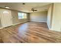 Bright living room showcasing new flooring, large windows, and a freshly painted interior at 1625 Meadow Lark Ln, Englewood, FL 34224