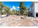 Spacious backyard with lush tropical landscaping and custom stone planters, perfect for outdoor entertaining at 20 Palm Dr, Placida, FL 33946