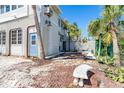 Charming exterior showcasing a private entrance and well-maintained yard with mature tropical plants and stone accents at 20 Palm Dr, Placida, FL 33946
