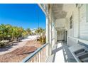 Inviting covered porch with serene views of the lush surroundings, perfect for enjoying the outdoors at 20 Palm Dr, Placida, FL 33946