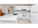 Modern kitchen featuring white cabinets, quartz countertops, and stainless steel appliances at 25100 Sandhill Blvd # R104, Punta Gorda, FL 33983