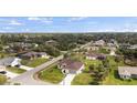 Aerial view of homes and property featuring lush greenery, tropical trees, and blue skies at 3084 Brockton St, North Port, FL 34286