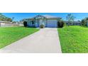 Charming single-story home featuring a well-manicured lawn and attached one car garage at 315 Southland Rd, Venice, FL 34293