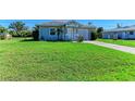 Charming single-story home featuring a well-manicured lawn and attached one car garage at 315 Southland Rd, Venice, FL 34293