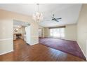 Open concept dining and living space with a chandelier and ceiling fan at 3162 Iverson St, Port Charlotte, FL 33952