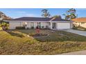 Single-story home with neutral exterior, tidy landscaping, and an attached two-car garage at 3265 Sunrise Trl, Port Charlotte, FL 33952