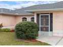 Close-up of the front entrance with a decorative storm door and arched windows at 4461 Baroda Ave, North Port, FL 34287