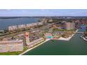 Aerial view of condo community with pool, waterfront access, and surrounding cityscape at 5020 Brittany S Dr # 324, St Petersburg, FL 33715