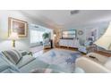 Inviting living area with hardwood floors, coastal-themed decor, and plenty of seating at 5020 Brittany S Dr # 324, St Petersburg, FL 33715