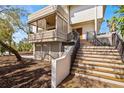 Home's front entrance shows a staircase and porch, with wood and neutral color accents at 5239 Siesta Cove Dr, Sarasota, FL 34242