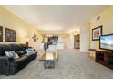 Spacious living room featuring neutral carpet, ample natural light, and open floor plan to dining area at 85 Vivante Blvd # 8542, Punta Gorda, FL 33950