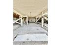 Open space under house with a raised platform, stairs, and structural support beams at 9400 Little Gasparilla Is # C2, Placida, FL 33946