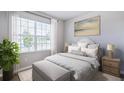 Bright bedroom with a large window, decorative pillows, and modern lamps at 9519 Turtle Grass Cir, Punta Gorda, FL 33950