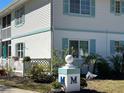 Well-maintained condo with turquoise shutters and landscaping provides curb appeal at 1051 Forrest Nelson Blvd # M 103, Port Charlotte, FL 33952