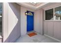 Inviting entryway features a bright blue front door and a welcoming mat at 1052 Archer St, Port Charlotte, FL 33952