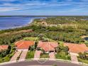 Aerial view of a home featuring a lush landscape, near waterfront property at 13049 Creekside Ln, Port Charlotte, FL 33953