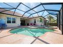 Screened pool area featuring a swimming pool and attached hot tub at 13049 Creekside Ln, Port Charlotte, FL 33953