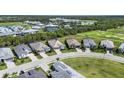 Aerial view of a home in a beautiful community with a golf course and several ponds at 14724 Cherry Blossom Way, Punta Gorda, FL 33955