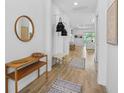 A bright foyer with wood-look tile flooring and stylish decorative elements at 14724 Cherry Blossom Way, Punta Gorda, FL 33955