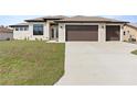 Charming single-story home featuring a spacious three-car garage and well-manicured lawn, illuminated for daytime appeal at 23218 Fawn Ave, Punta Gorda, FL 33980