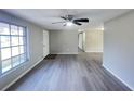 Open living space with gray wood flooring, ceiling fan, and natural light at 2507 Linton Ln, Port Charlotte, FL 33952