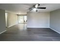 Spacious living room with new gray wood flooring and natural light from sliding patio doors at 2507 Linton Ln, Port Charlotte, FL 33952