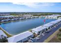 A scenic view of lakeside condos offering a tranquil setting with recreational activities, surrounded by natural beauty at 3310 Loveland Blvd # 1808, Punta Gorda, FL 33980