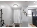 The entryway features neutral walls, tile flooring, coat rack, and a glimpse into the kitchen at 3310 Loveland Blvd # 1808, Punta Gorda, FL 33980