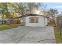 Home exterior with an extended driveway and mature trees at 6534 29Th N Way, St Petersburg, FL 33702