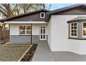 Beautifully updated home with white exterior, gray accents and a manicured front lawn at 6534 29Th N Way, St Petersburg, FL 33702