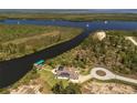 Aerial view of a stunning waterfront home with private dock and bay access at 9149 Lane Ct, Port Charlotte, FL 33981