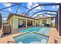 Gorgeous pool with jacuzzi, large screened-in lanai, and outdoor kitchen at 9149 Lane Ct, Port Charlotte, FL 33981