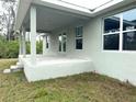 Image displays a covered back patio with ample space, perfect for outdoor entertaining and relaxation at 9590 Little Rock St, Port Charlotte, FL 33981