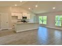 Bright open-concept kitchen featuring granite countertops, modern appliances, and tile flooring at 9590 Little Rock St, Port Charlotte, FL 33981