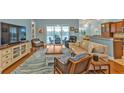 Comfortable living room with hardwood floors, blue walls, and view of the screened in patio at 13096 N Marsh Dr, Port Charlotte, FL 33953