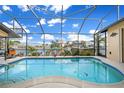Relaxing screened-in pool area with a waterfront view offers the perfect retreat at 1336 Casey Key Dr, Punta Gorda, FL 33950