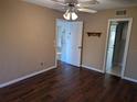 Bedroom with wood floors, ceiling fan, closet, and doorways to other rooms at 1340 San Cristobal Ave # 207, Punta Gorda, FL 33983
