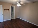 Cozy bedroom featuring wood floors, a ceiling fan, and a doorway to the bathroom at 1340 San Cristobal Ave # 207, Punta Gorda, FL 33983