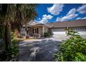 Lovely single-story home featuring a large driveway, attached garage, and well maintained landscaping at 1355 Red Oak Ln, Port Charlotte, FL 33948