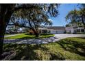Charming home featuring a lush landscaped front yard with a welcoming two-car garage at 1474 Red Oak Ln, Port Charlotte, FL 33948
