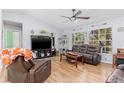 Cozy living room with wood floors, comfortable seating, and plenty of natural light at 1702 Rice Ter, North Port, FL 34286