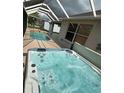 Close up shot of screened-in hot tub on lanai next to pool at 1859 Scarlett Ave, North Port, FL 34289