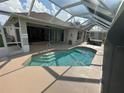 Screened-in pool with attached hot tub and covered lanai provides a relaxing outdoor space at 1859 Scarlett Ave, North Port, FL 34289