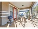 Enjoy the outdoors on this screened-in porch with a grill and comfortable seating at 1859 Scarlett Ave, North Port, FL 34289
