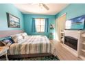 Bright bedroom with wood floors, ceiling fan, flatscreen TV, and coastal decor at 2002 Bal Harbor Blvd # 311, Punta Gorda, FL 33950