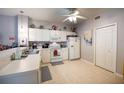 Bright kitchen features white cabinets, tiled flooring, and a full suite of appliances at 2002 Bal Harbor Blvd # 311, Punta Gorda, FL 33950
