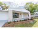 Inviting single-story home with white painted brick, manicured landscaping, and well-maintained lawn at 20191 Gladstone Ave, Port Charlotte, FL 33952